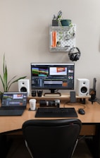 A desk with a computer and speakers on it