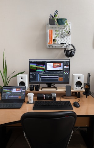 A desk with a computer and speakers on it