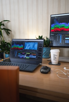 A laptop computer sitting on top of a wooden desk
