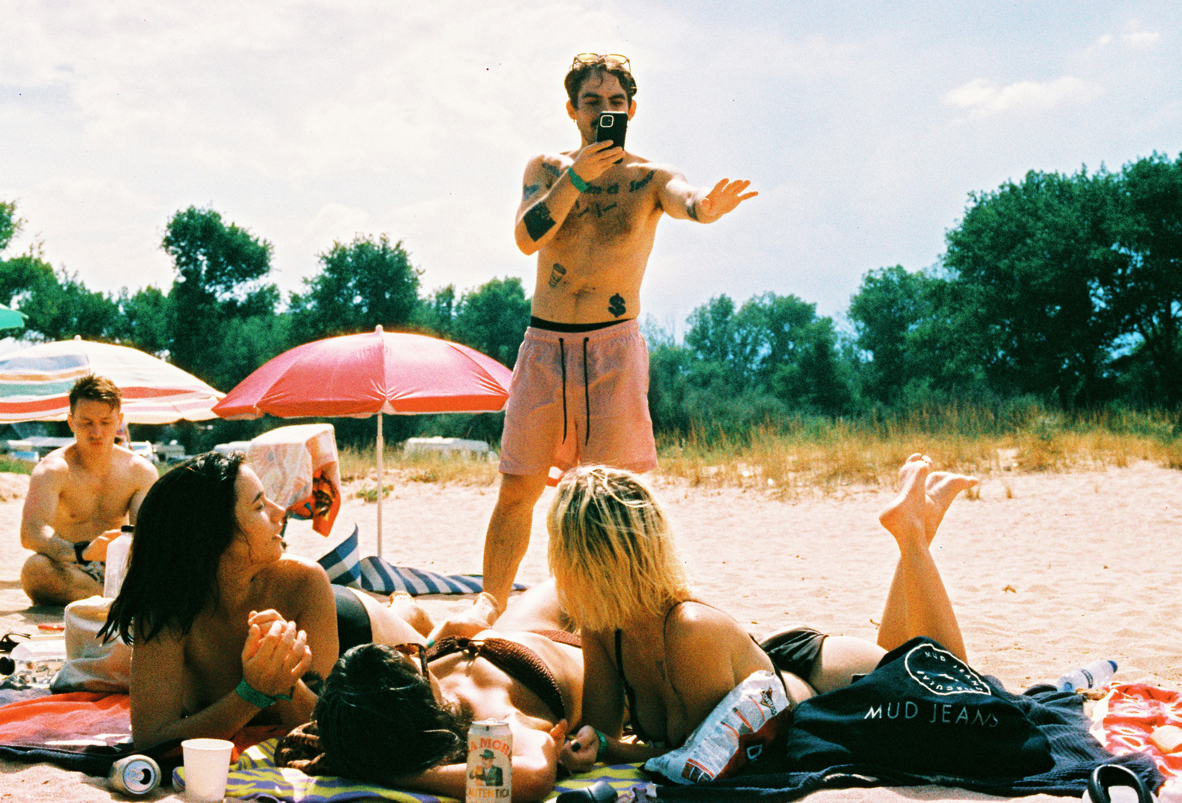 A man standing on top of a beach next to a group of people