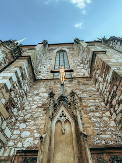 A very tall building with a cross on the top of it