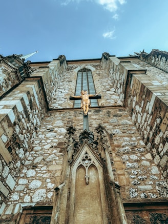 A very tall building with a cross on the top of it