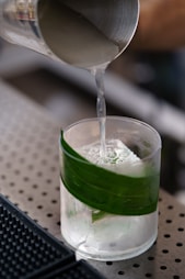 A person pouring a drink into a glass