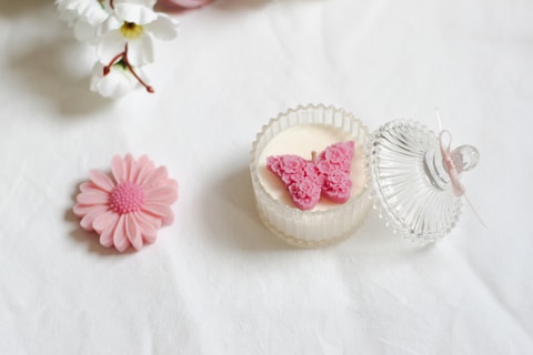 A white table topped with pink and white flowers