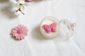 A white table topped with pink and white flowers