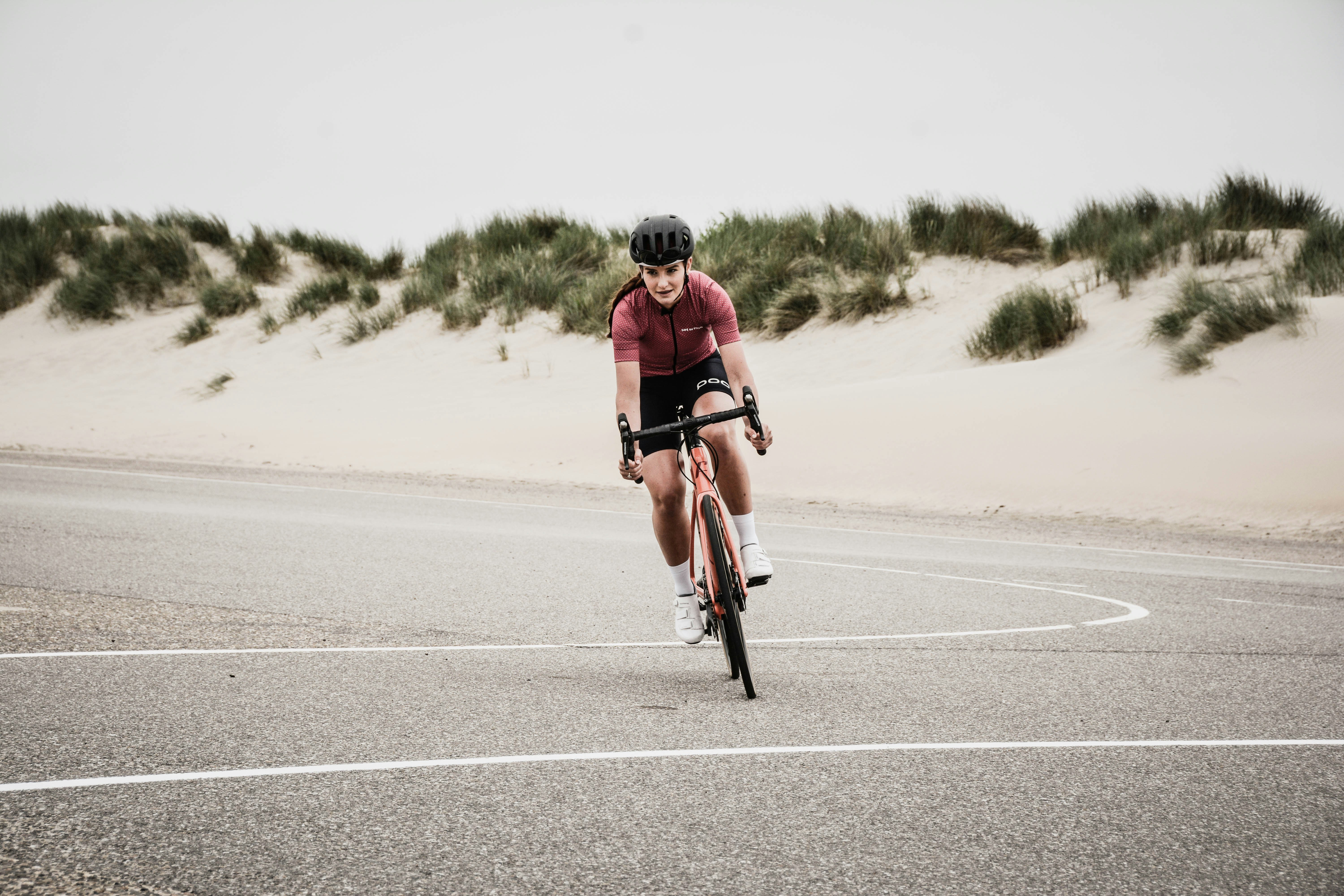 A man riding a bike down a curvy road