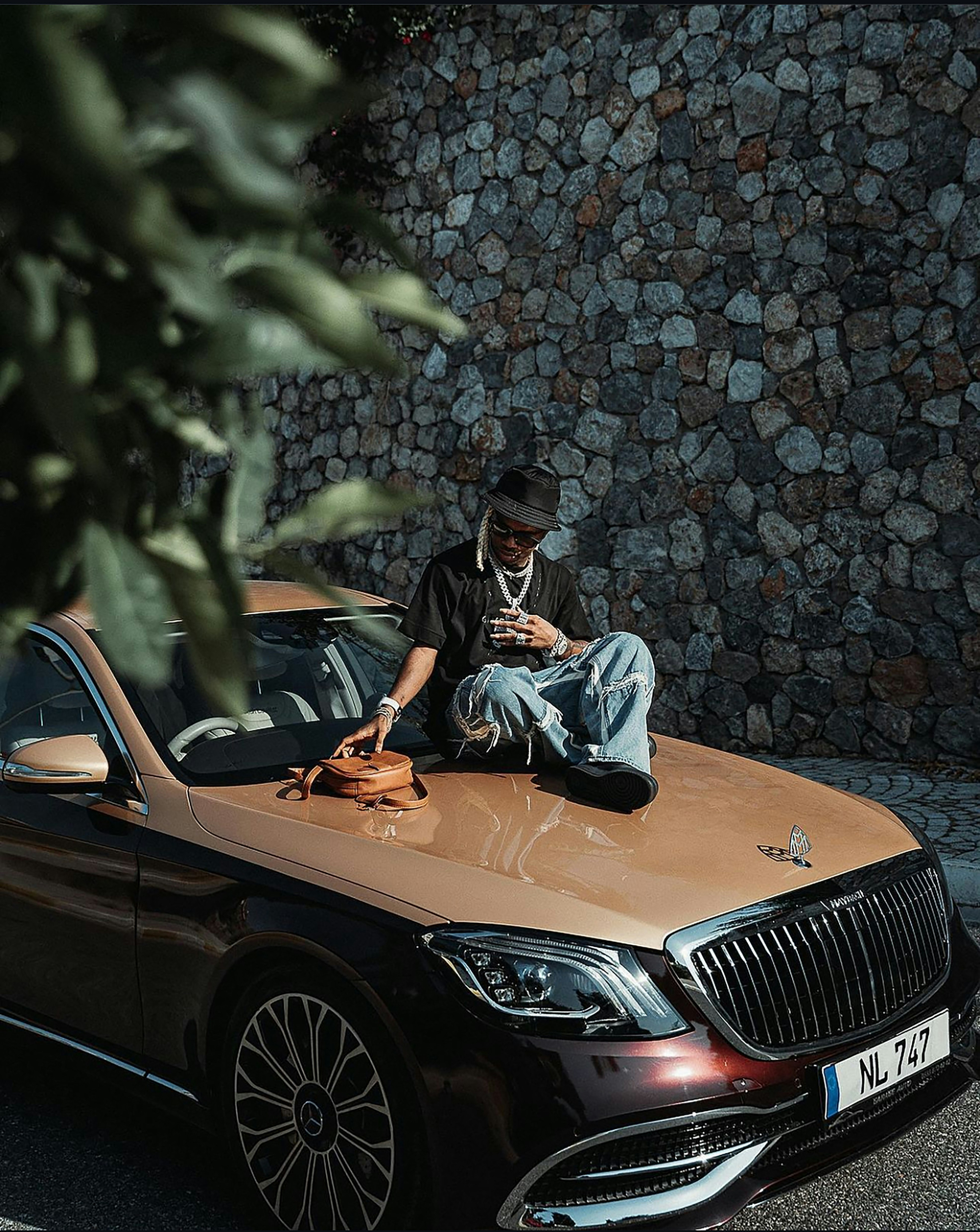 A man sitting on the hood of a car