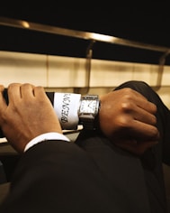 A man in a suit is holding onto a tie