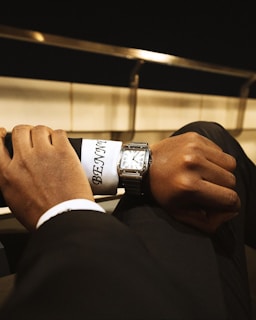 A man in a suit is holding onto a tie