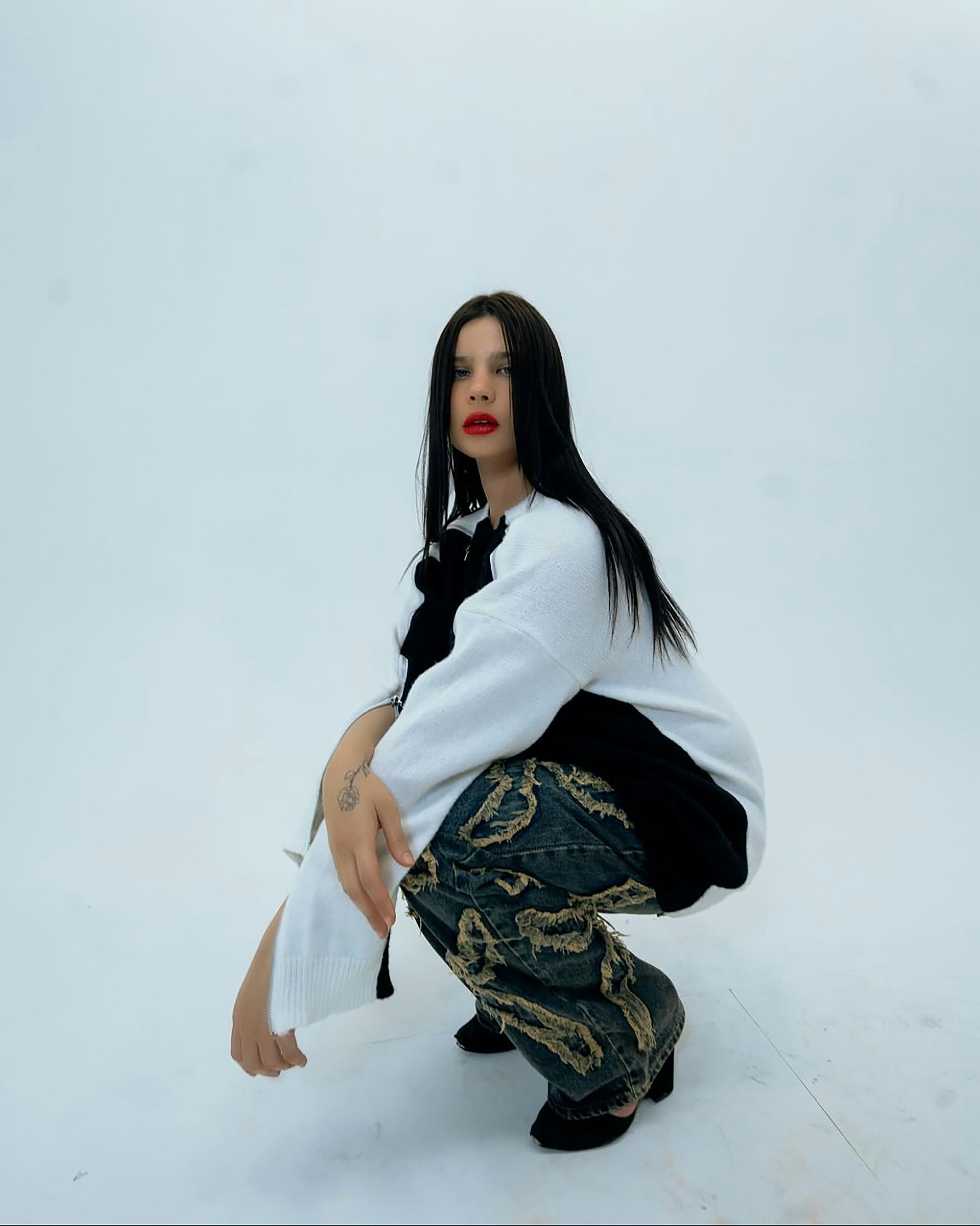 A woman kneeling down in the snow