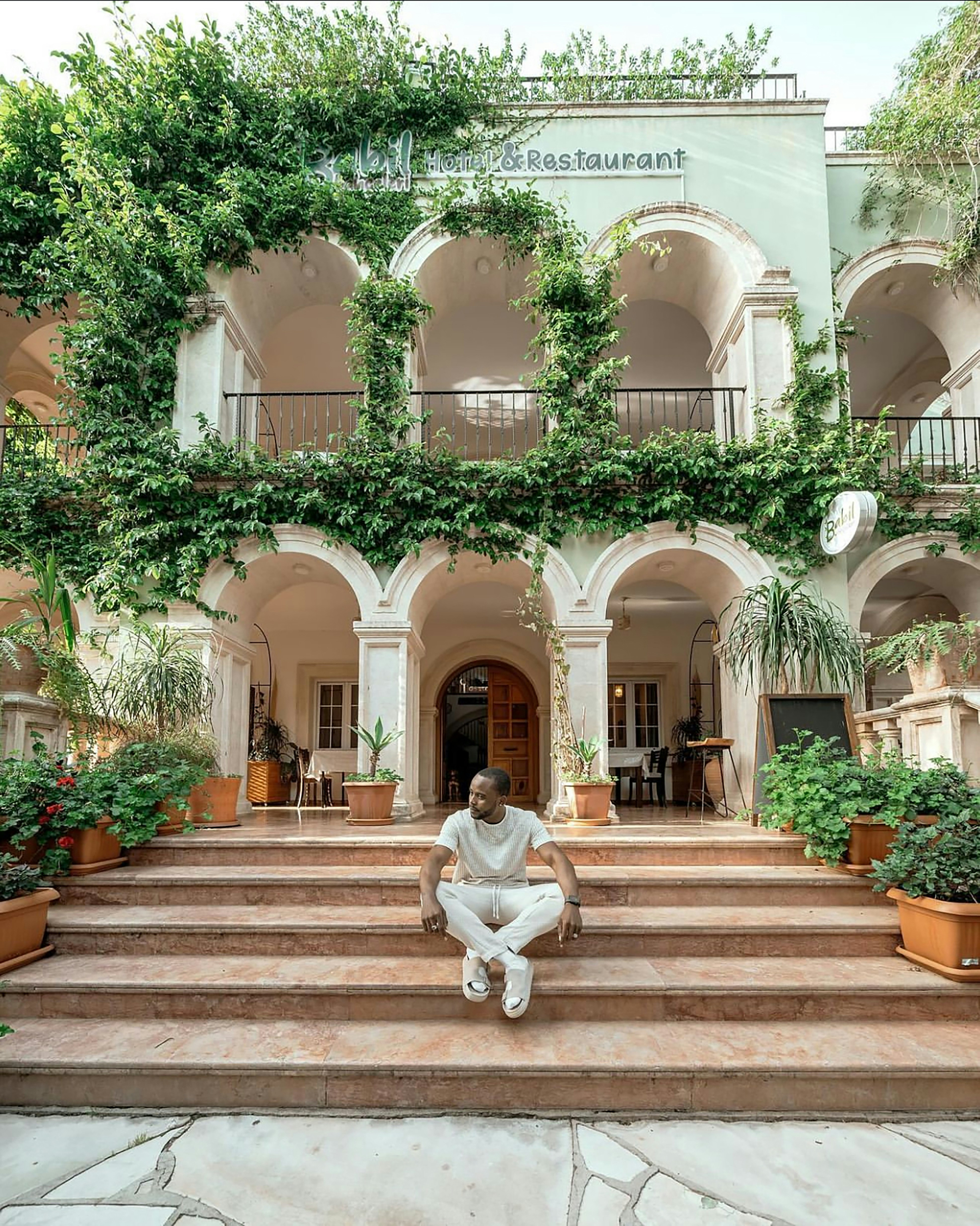 A man sitting on a set of steps in front of a building