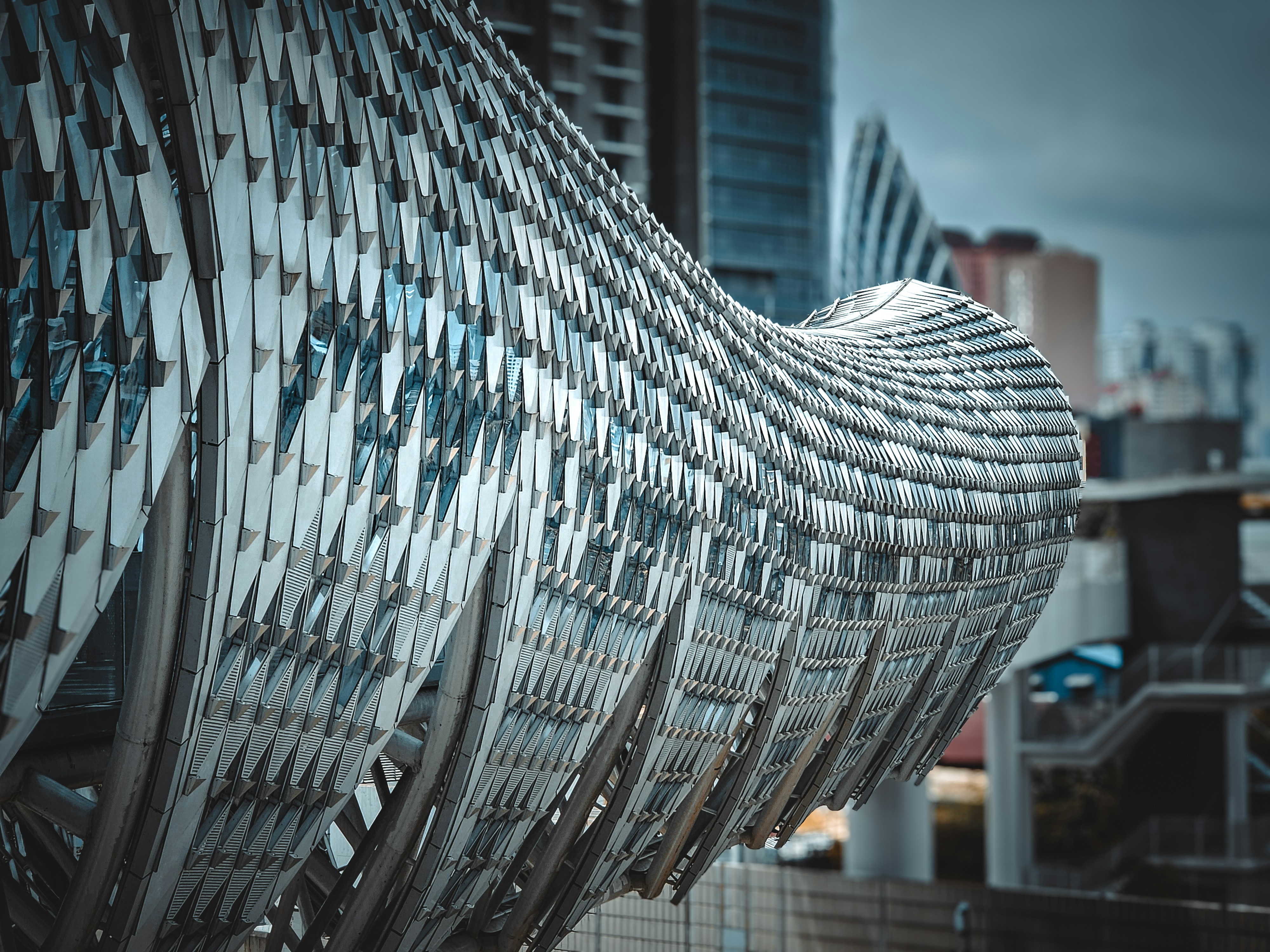 A close up of a metal structure with buildings in the background