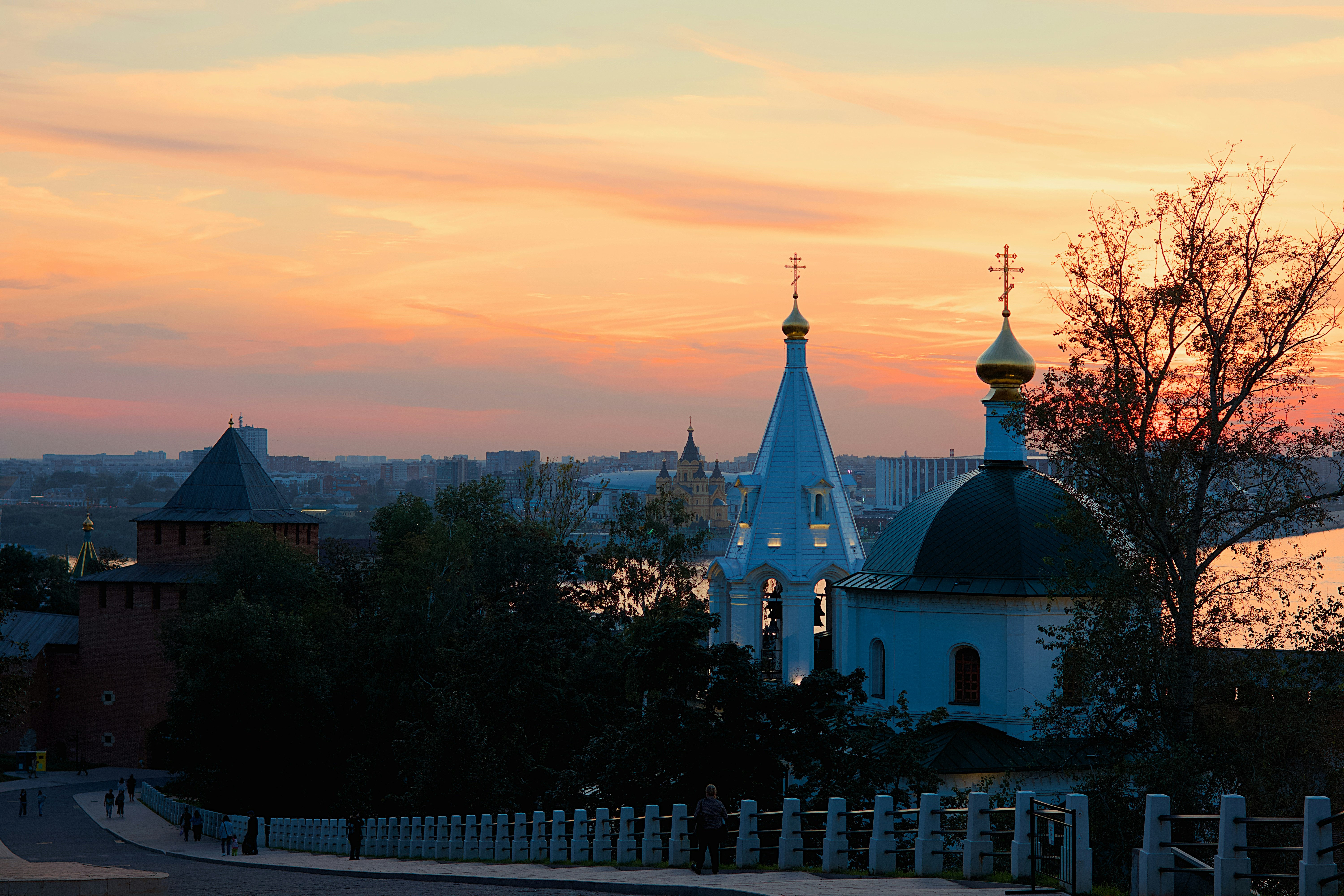 A view of a church with a sunset in the background