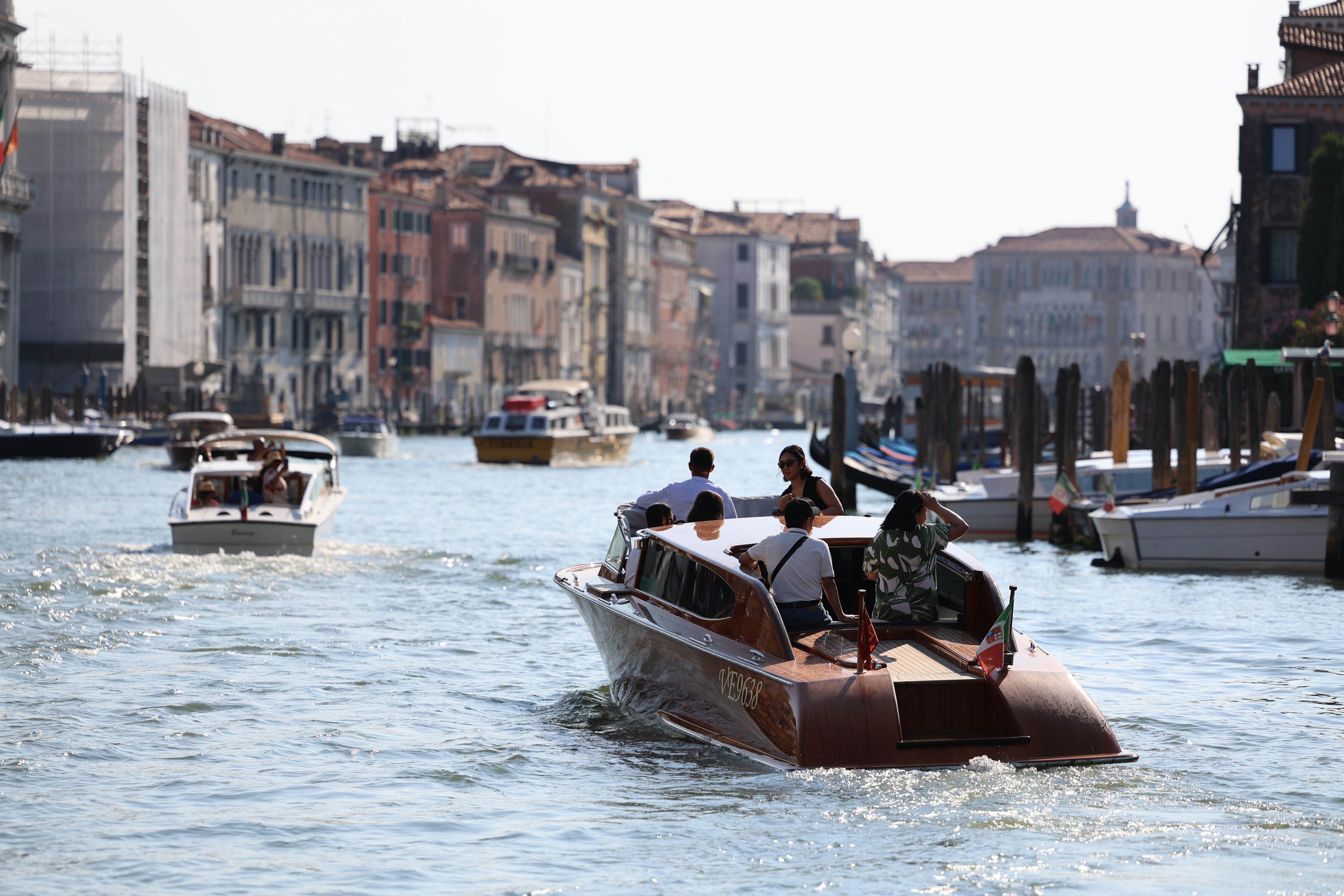 A group of people riding on top of a boat down a river