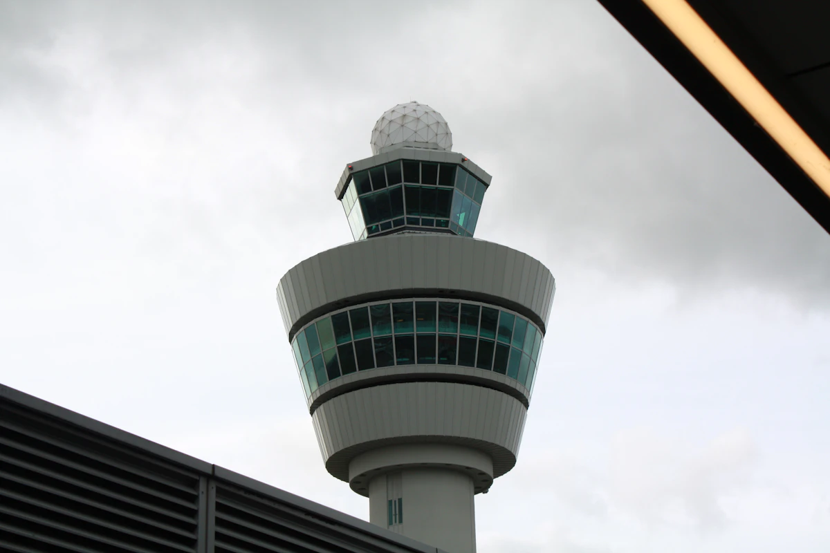 An airport control tower against a clear sky