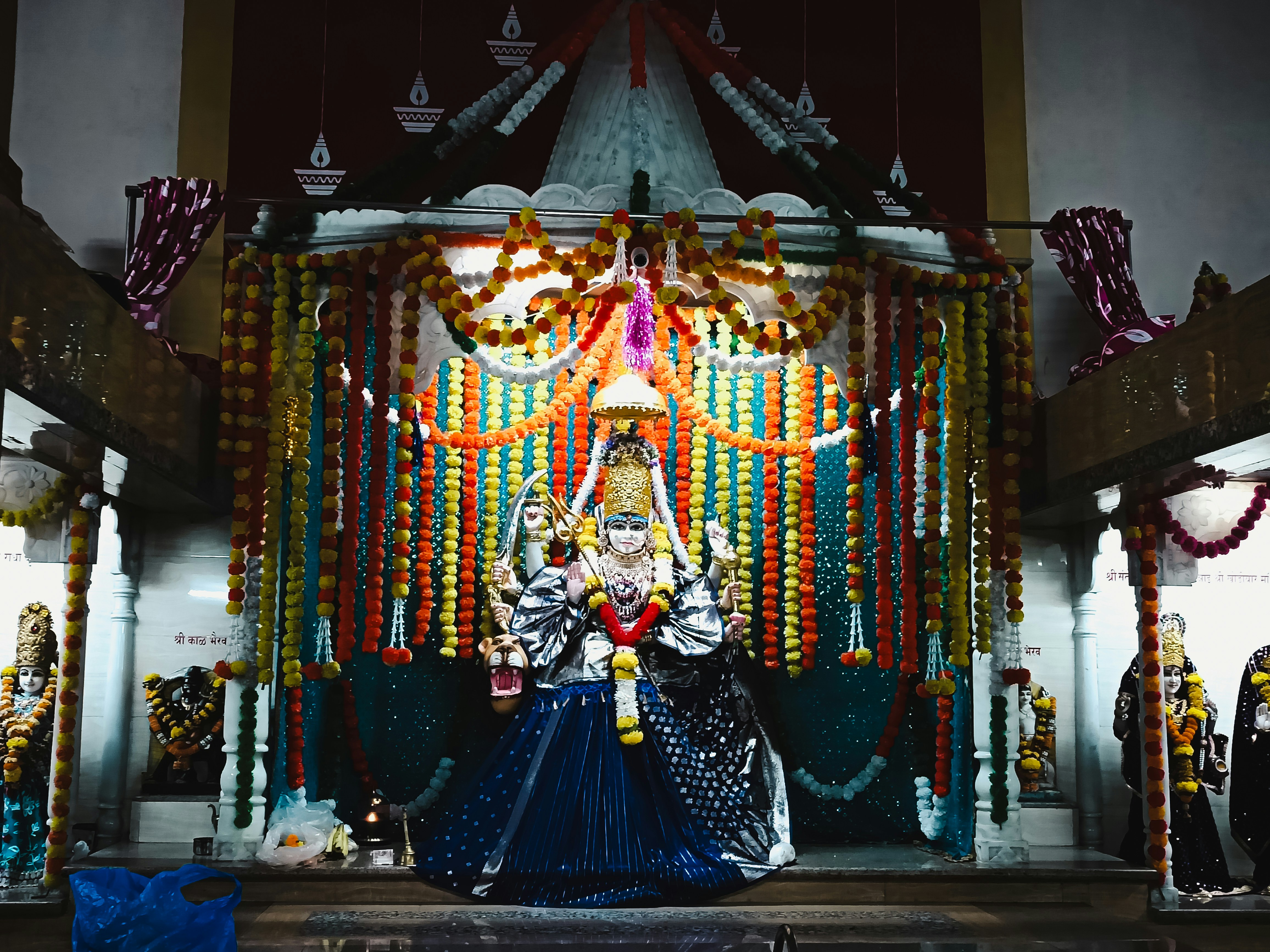 A woman in a blue dress standing in front of a stage