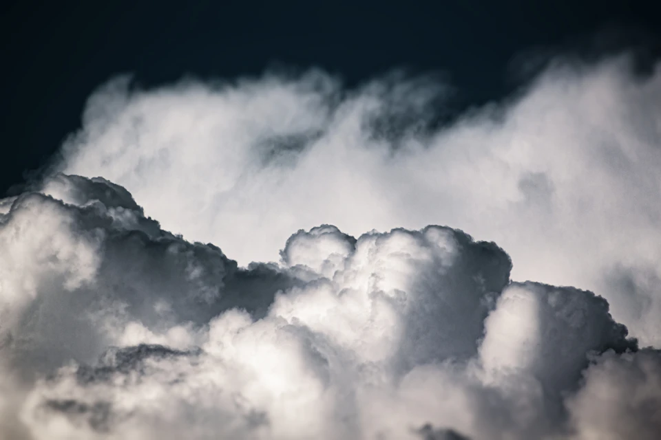 Vast expanse of sky filled with fluffy white clouds creates an ethereal atmosphere above