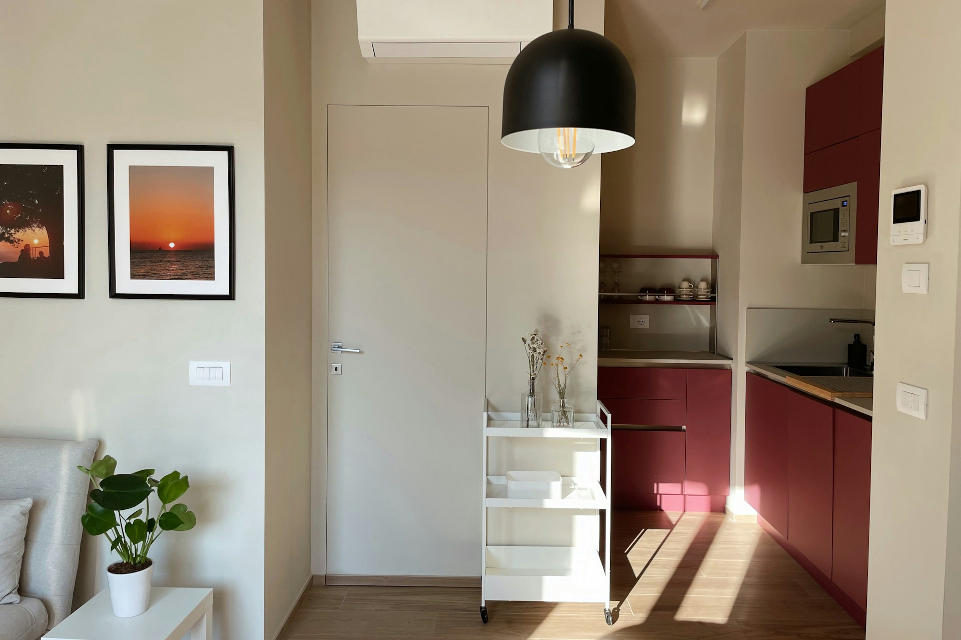 A living room with a couch a table and pictures on the wall