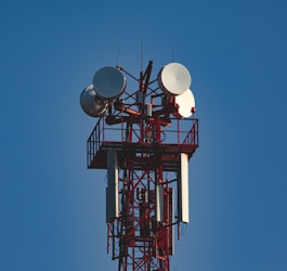 A tall tower with a bunch of antennas on top of it