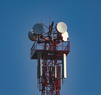 A tall tower with a bunch of antennas on top of it