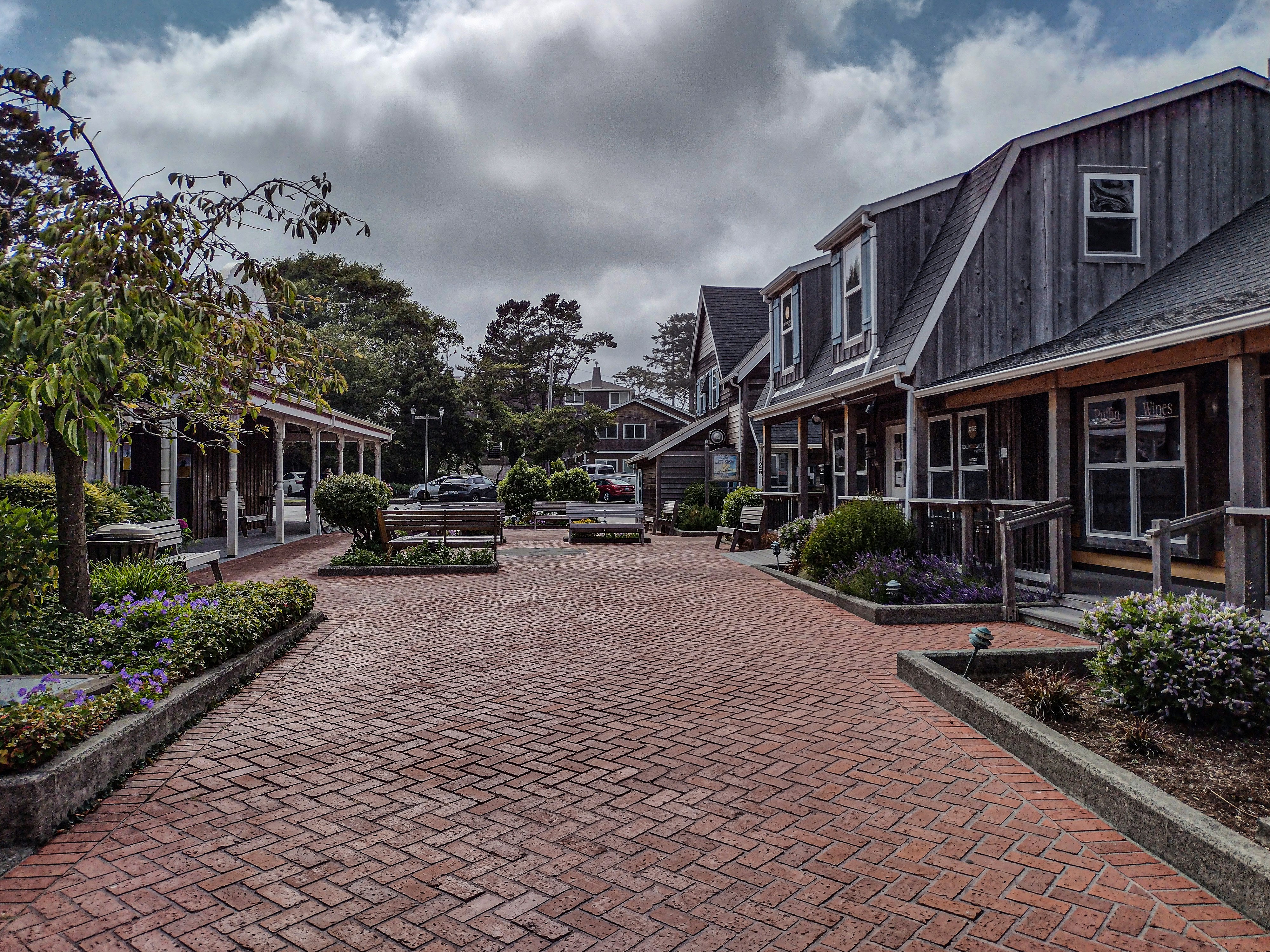 A brick walkway leading to a row of houses