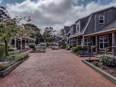 A brick walkway leading to a row of houses
