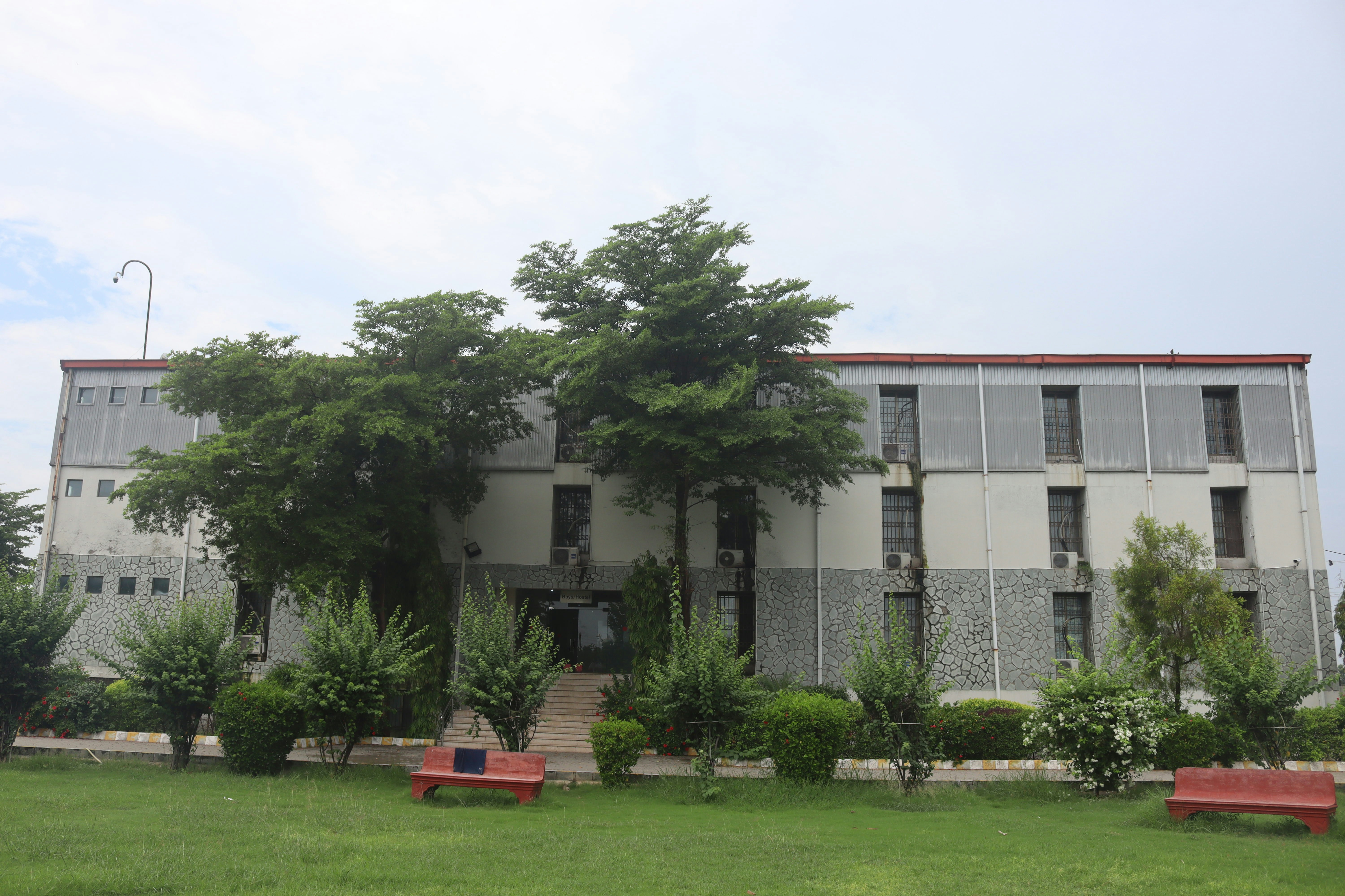 A large building with a bunch of trees in front of it