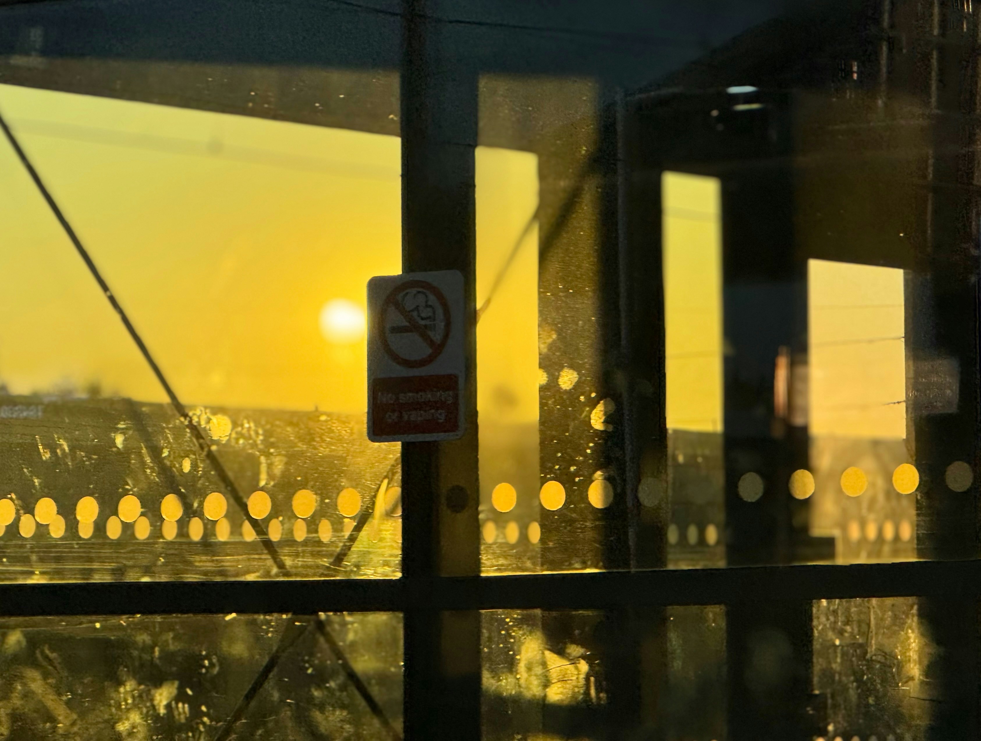 A window with a view of a city at sunset