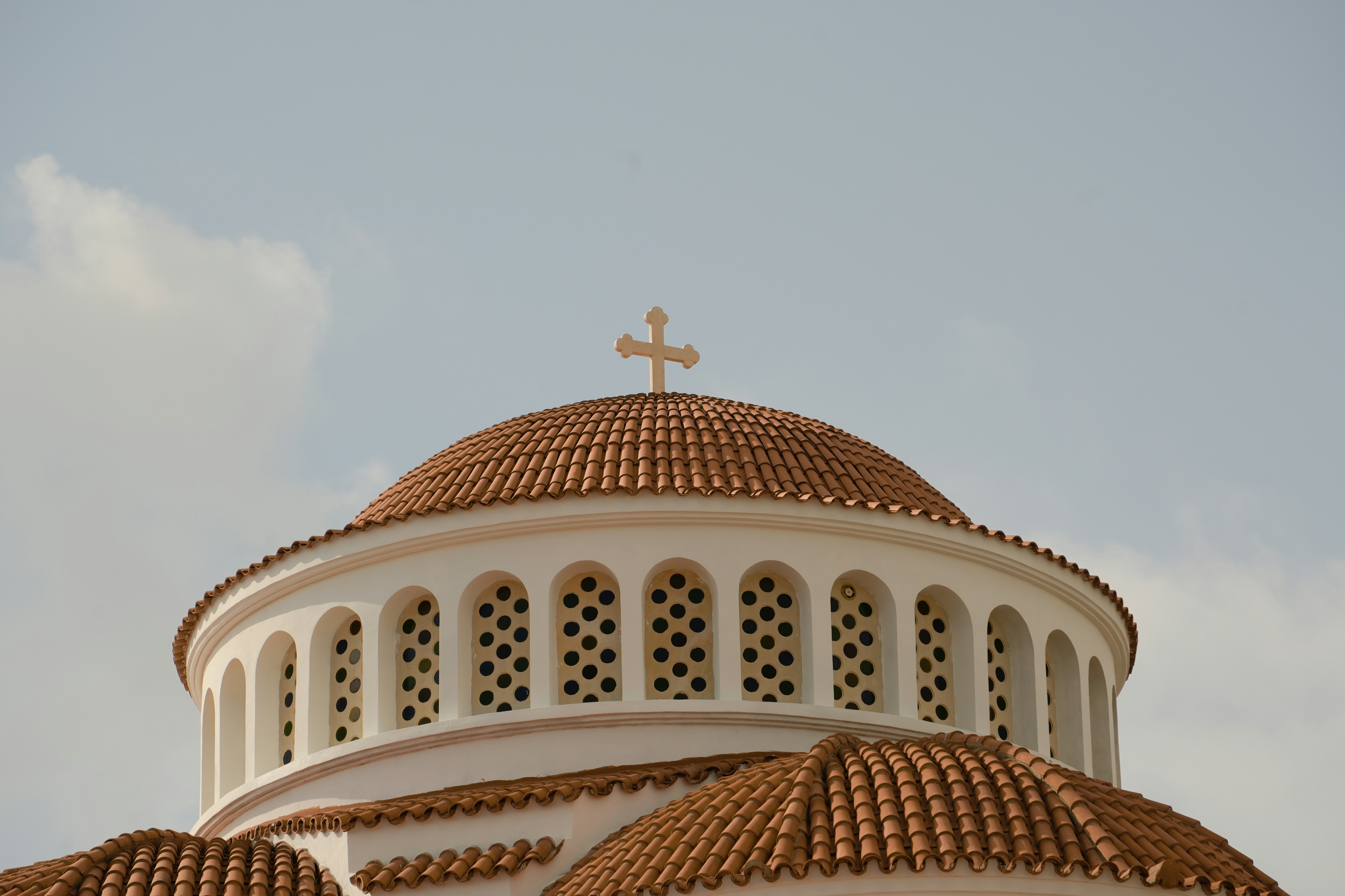 A large white building with a cross on top