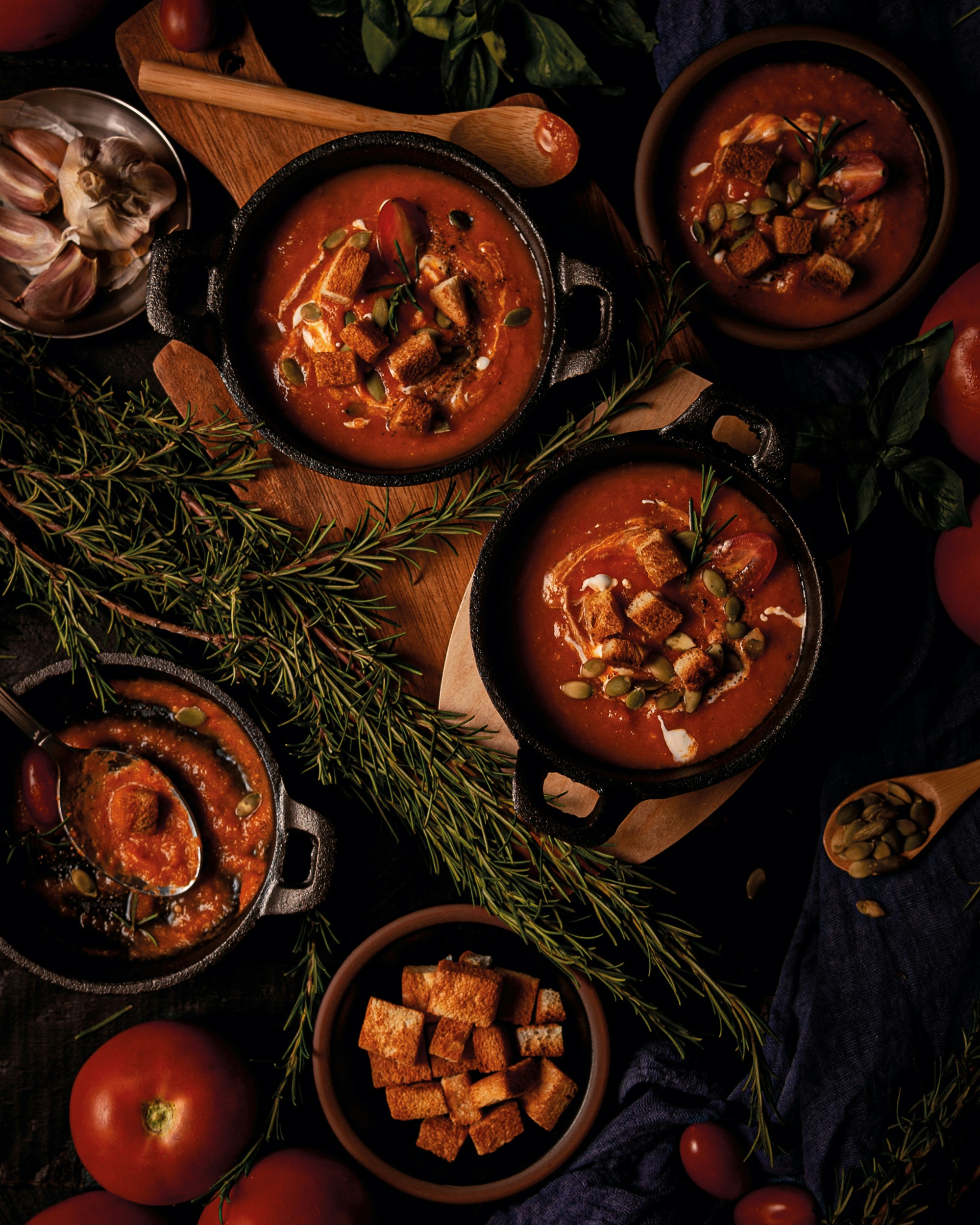 A table topped with bowls of soup and vegetables