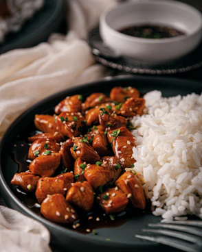 A plate of chicken and rice on a table