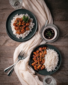 Two plates of food on a wooden table