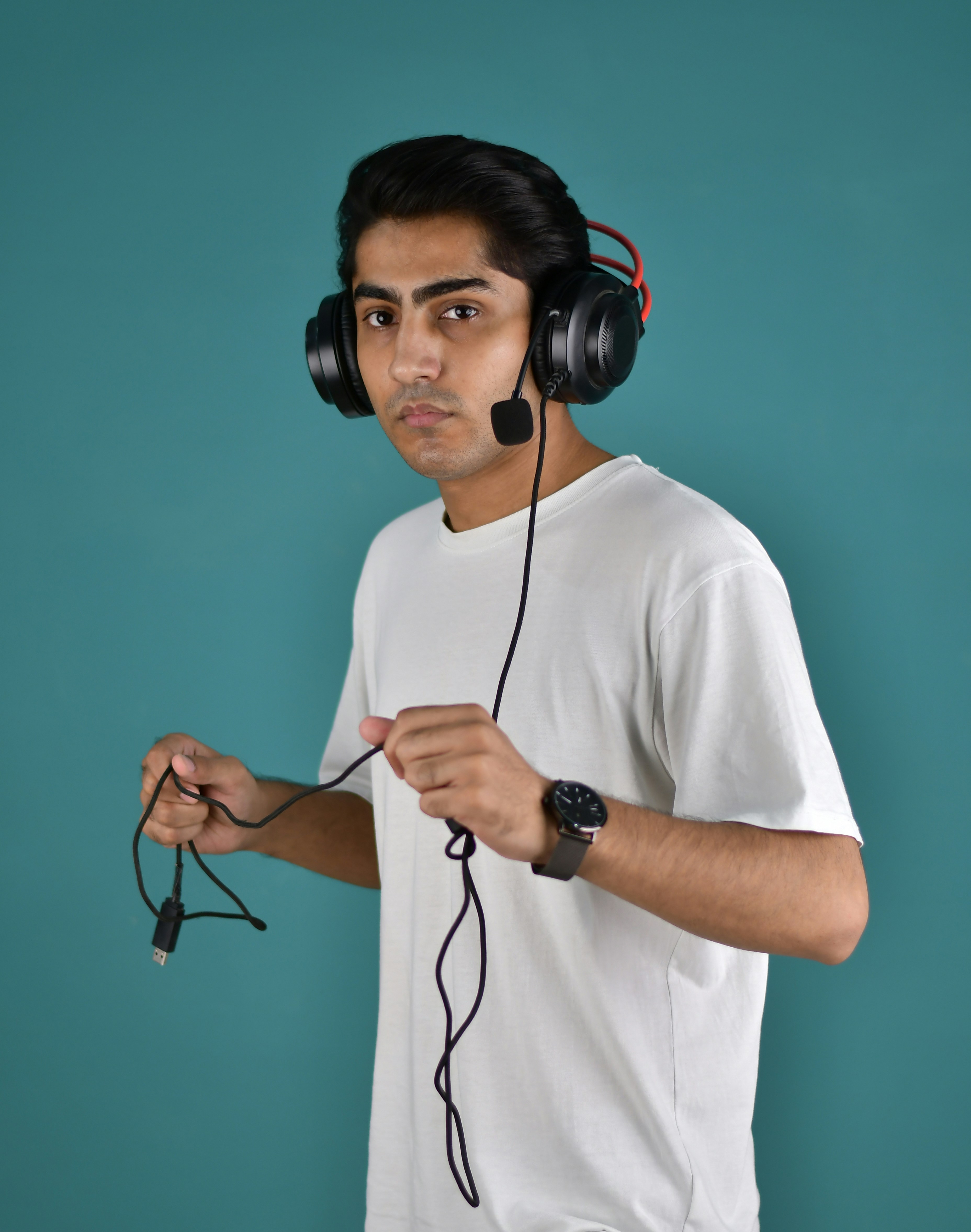 A man wearing headphones and a white t - shirt
