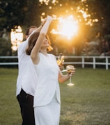 A man and a woman holding glasses of wine