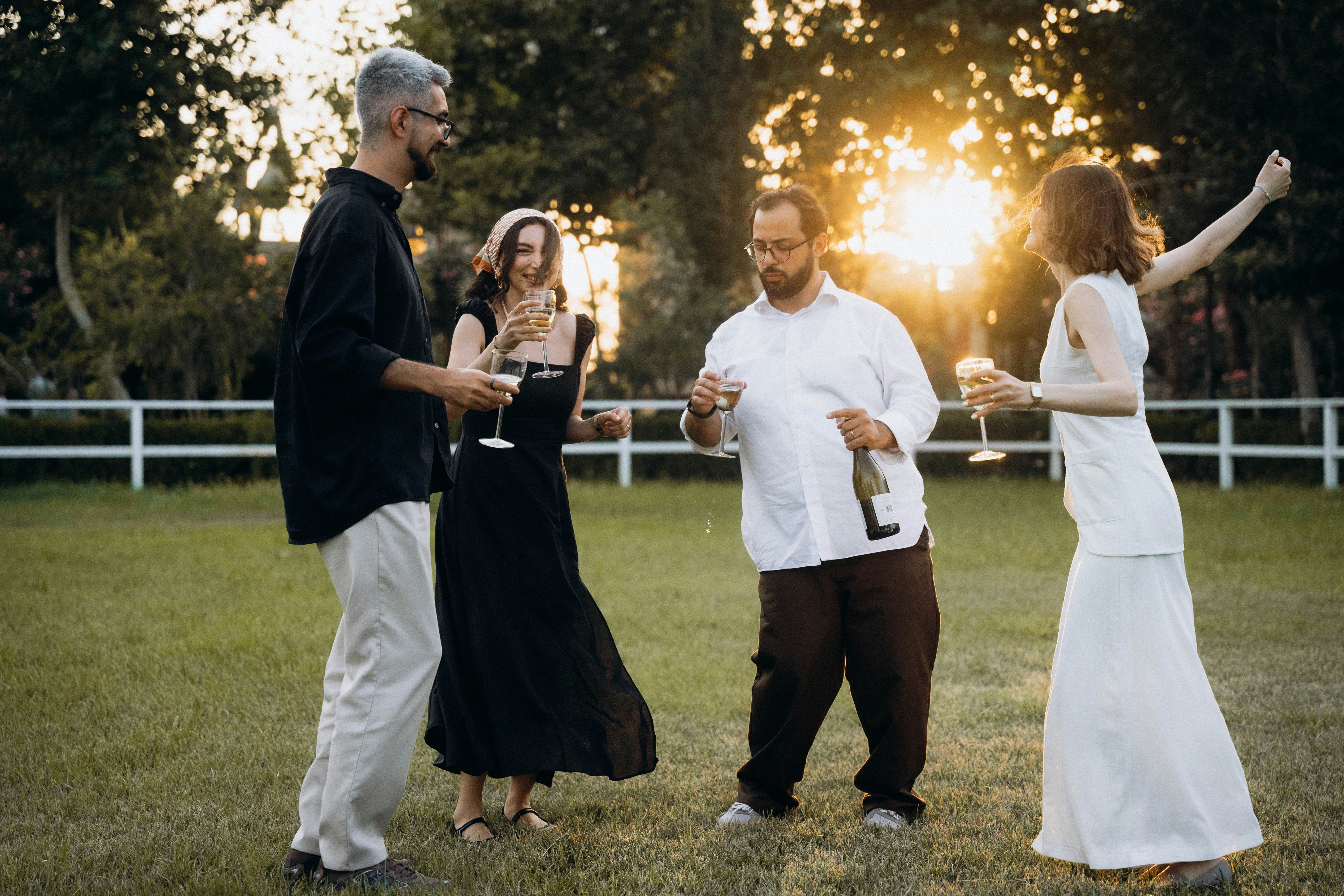 A group of people standing on top of a lush green field