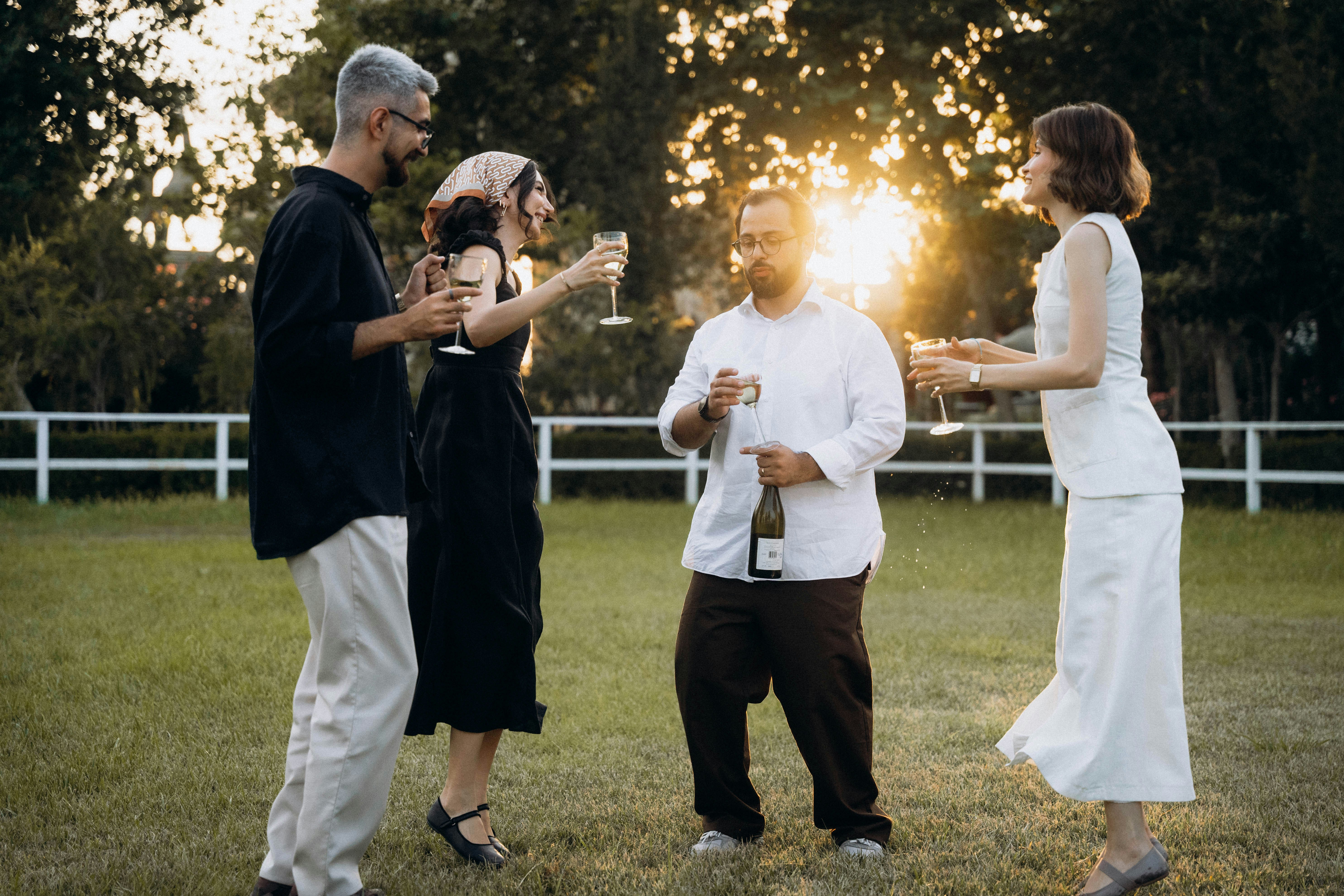A group of people standing on top of a lush green field