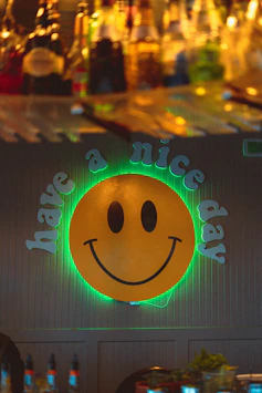 A bar with a neon sign that says make a smile