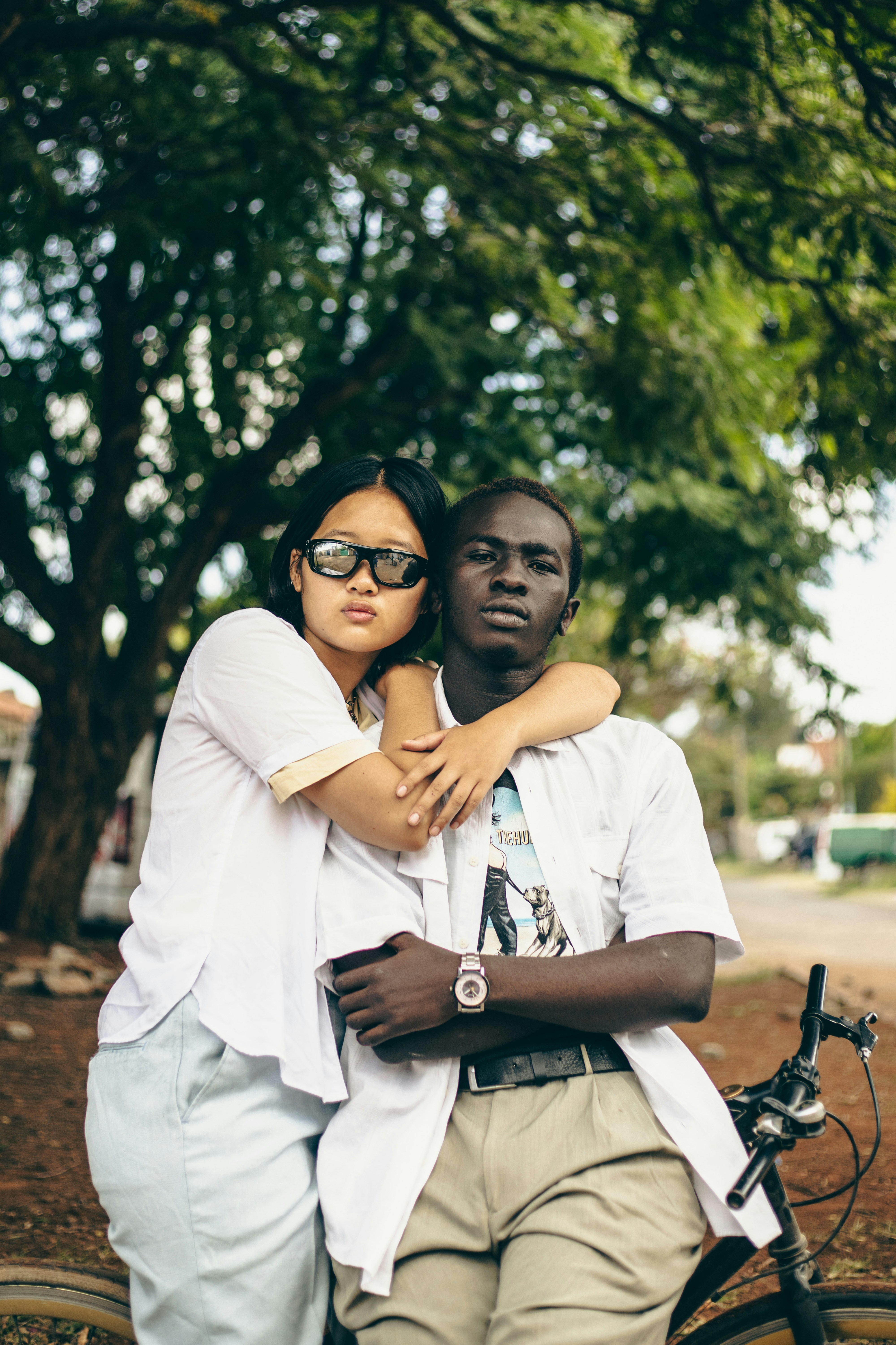 A man and a woman standing next to a bike