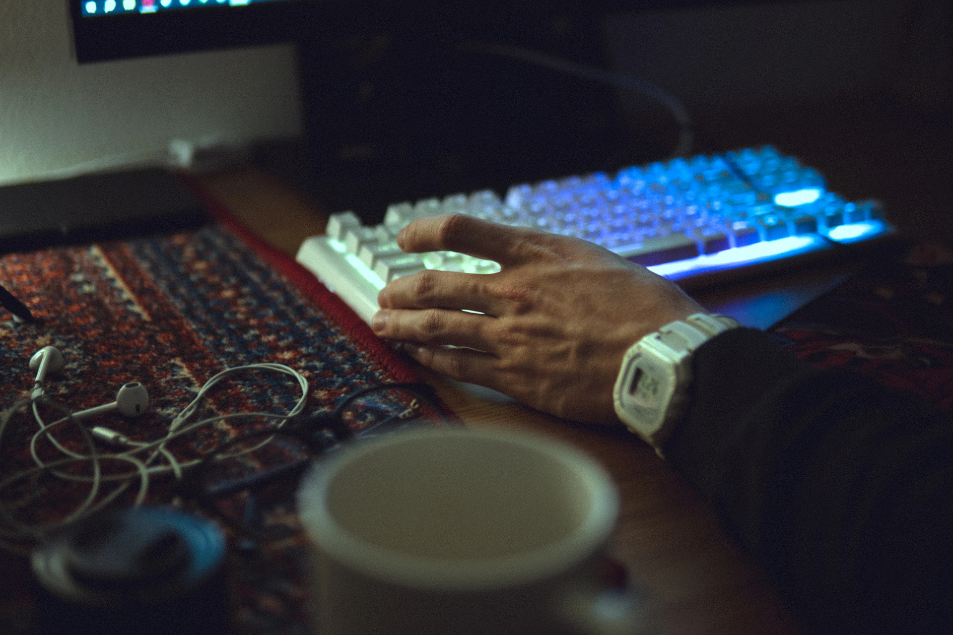 A man is typing on a computer keyboard