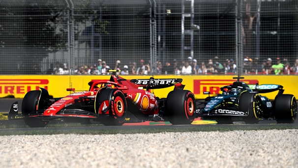A red and yellow race car driving on a track