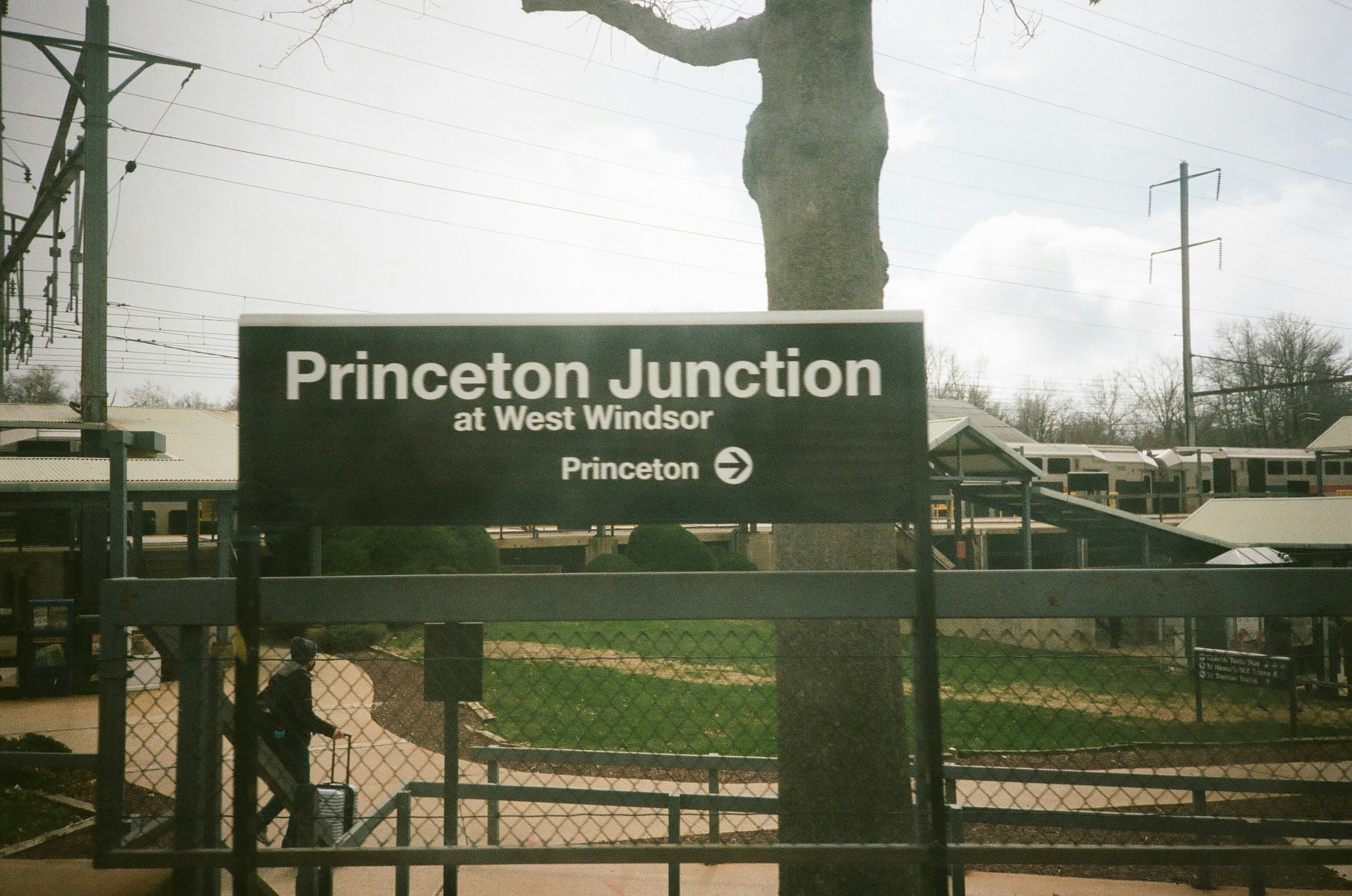 A sign that is in front of a fence