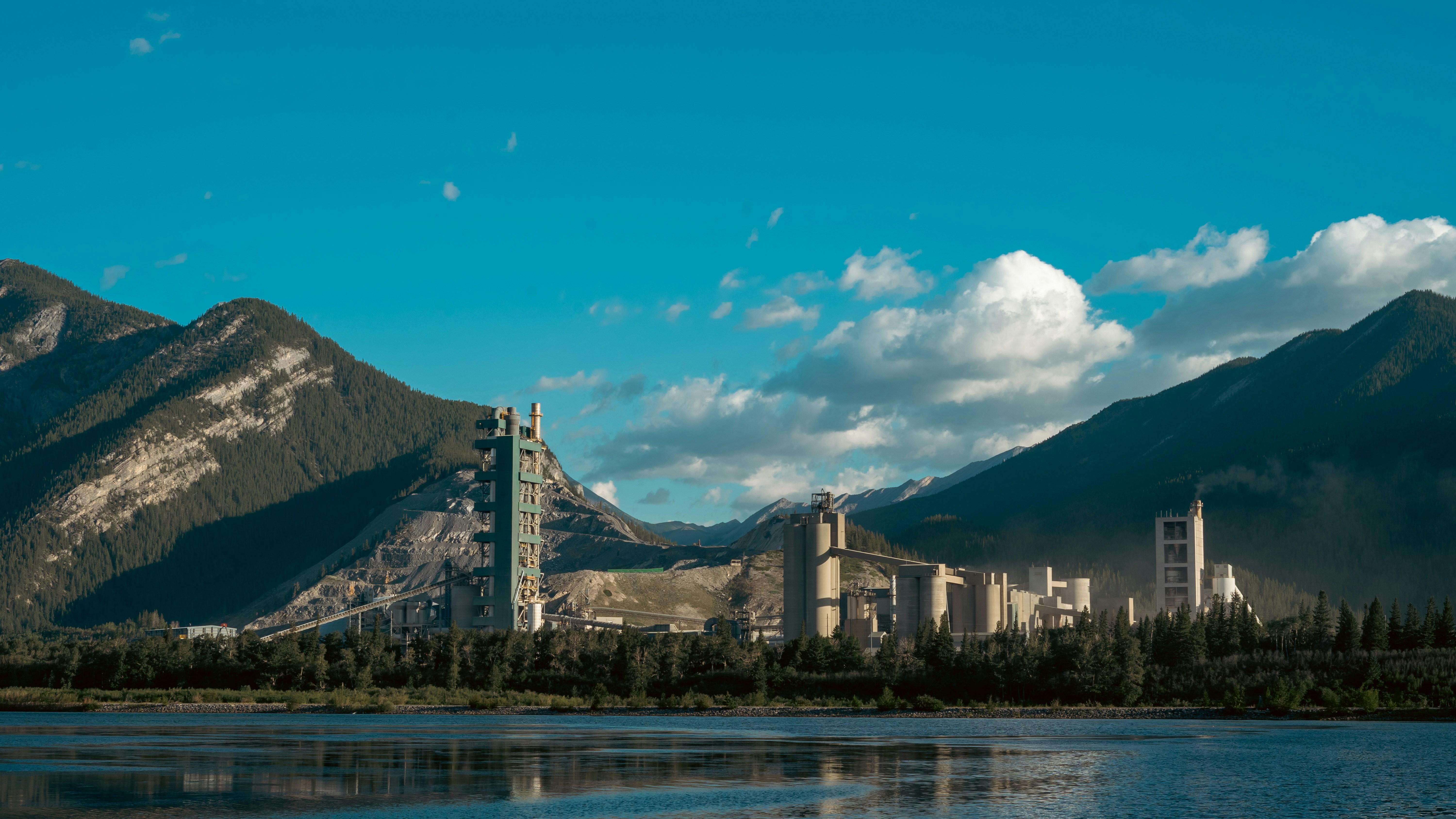 A lake surrounded by mountains with a city in the background