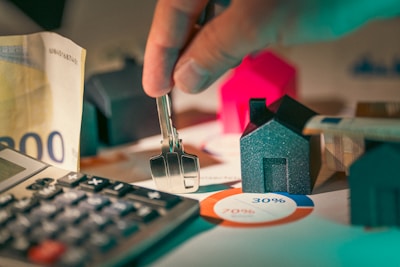 key, calculator, home data, and a mini house for homebuyers and mortgage payers
