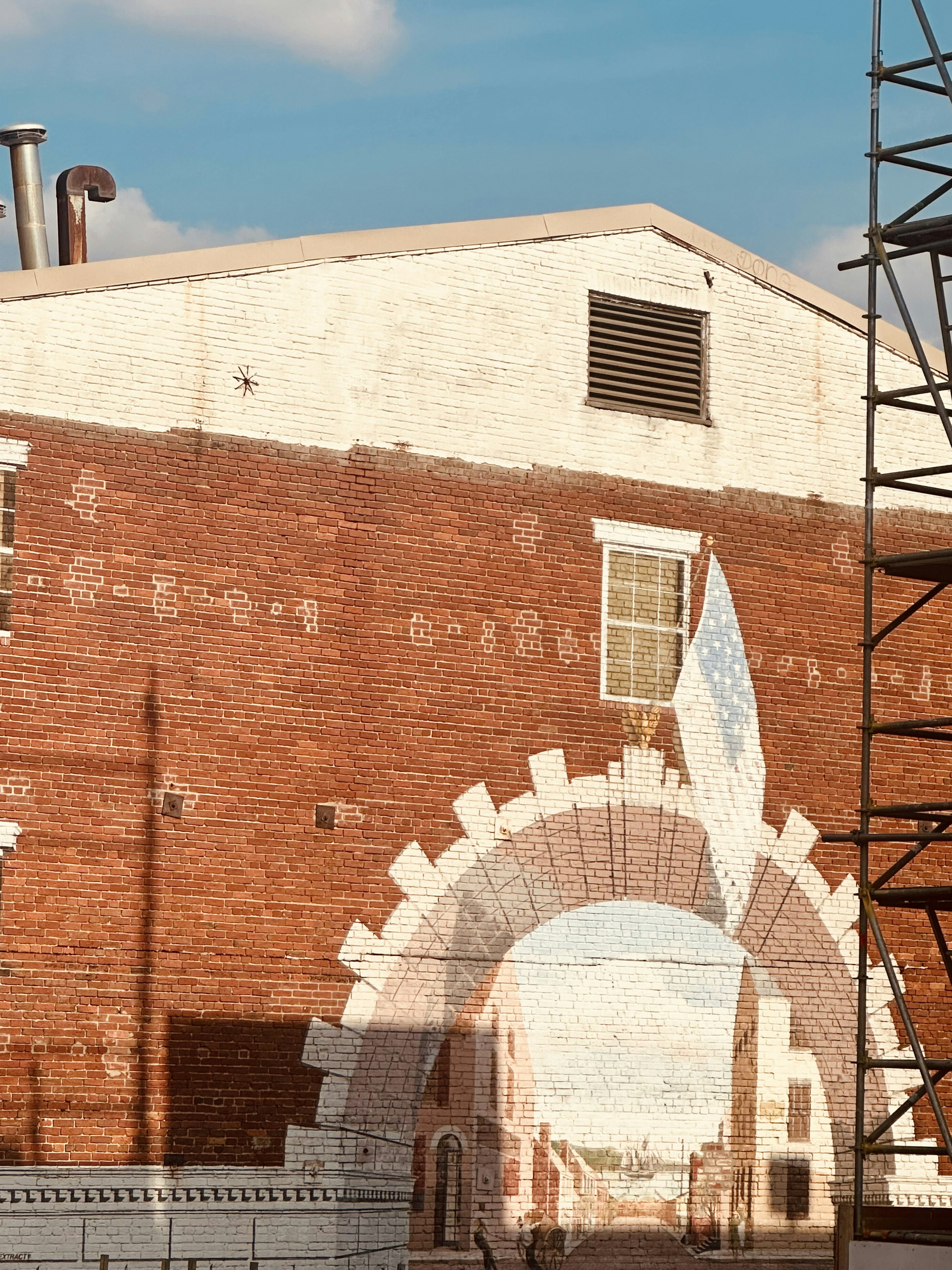 A brick building with a clock on the side of it