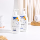 A couple of bottles of lotion sitting on a counter