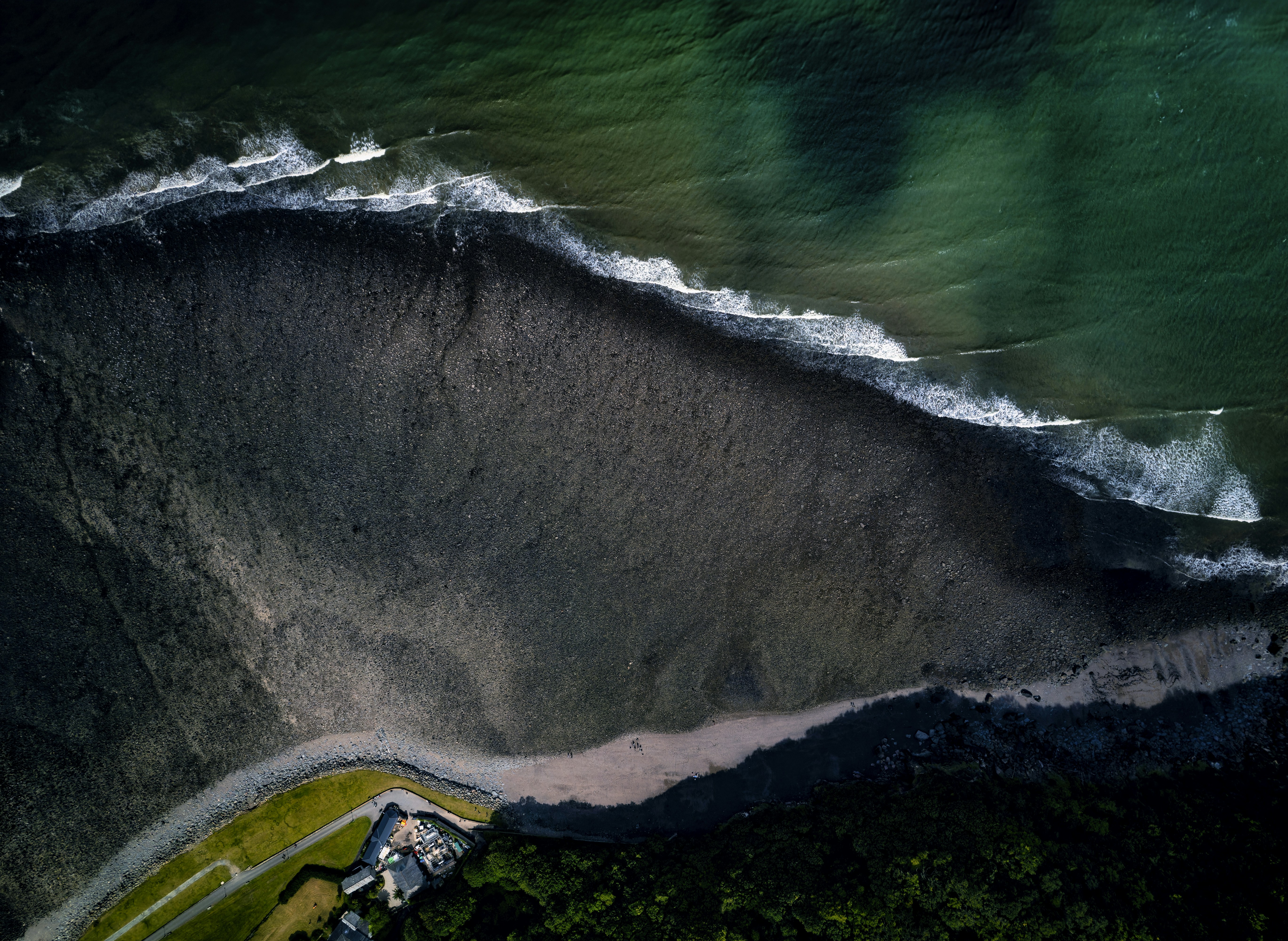An aerial view of the ocean with waves