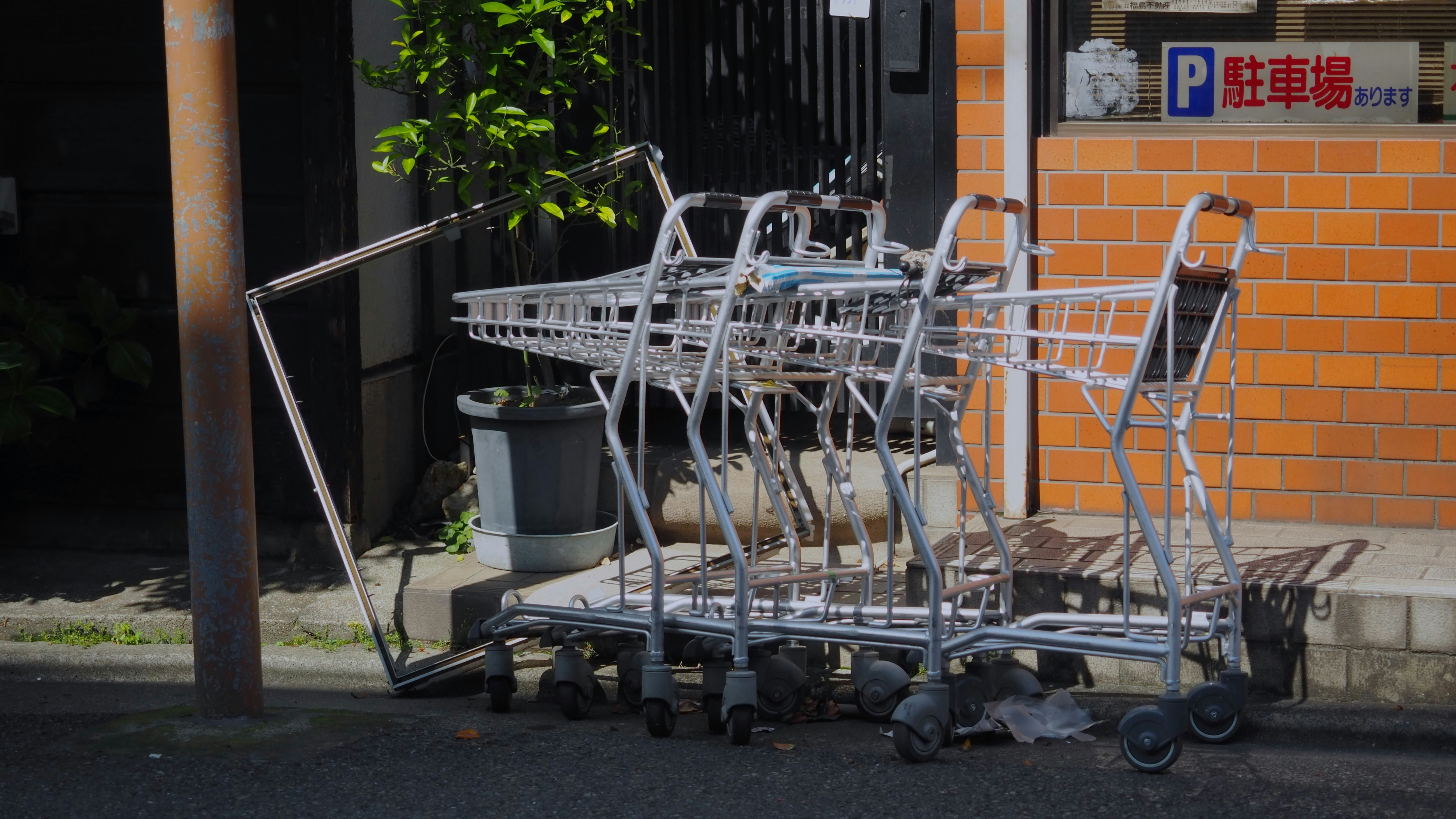 A pile of luggage sitting on the side of a road
