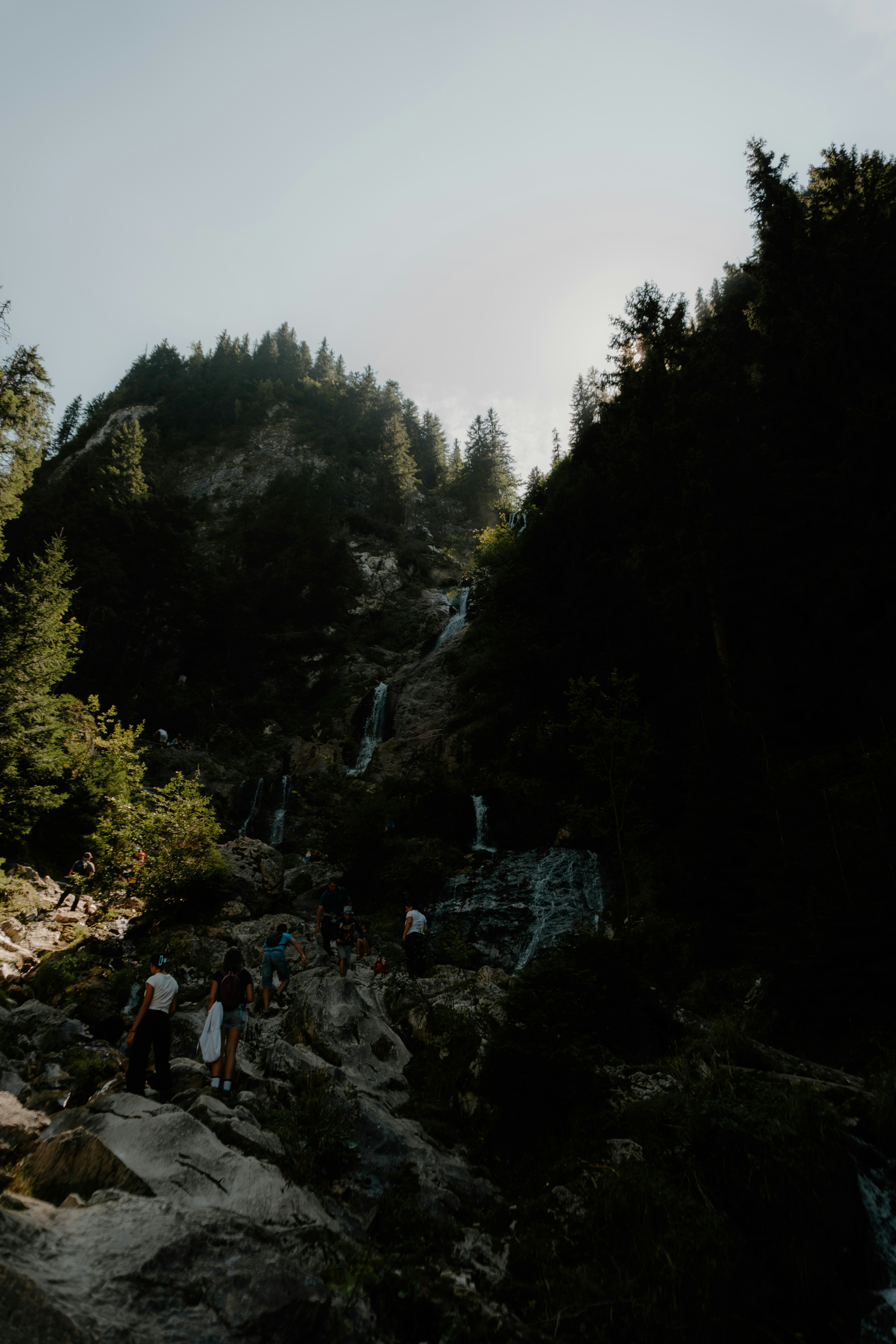 A group of people standing on top of a waterfall