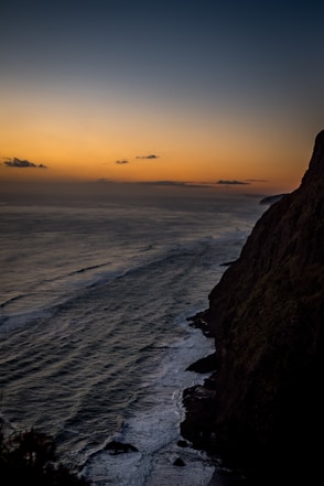 A view of the ocean at sunset from a cliff