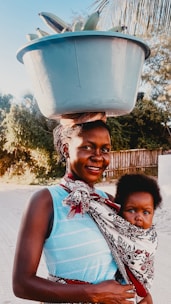 A woman carrying a child on her back